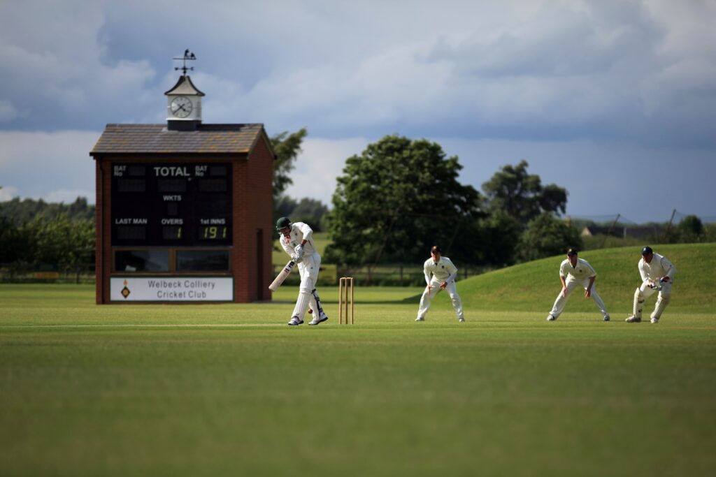 group of person playing cricket